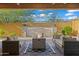Covered back patio with fire pit, outdoor seating, and stone water feature at 1915 N Bernard Cir, Mesa, AZ 85207