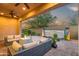 Covered patio with a fire pit, outdoor seating, and a water feature at 1915 N Bernard Cir, Mesa, AZ 85207