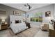 Cozy bedroom features a large bed, a comfortable armchair, and a large window at 1915 N Bernard Cir, Mesa, AZ 85207