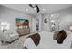 Well-lit bedroom with ceiling fan, TV, and view into adjoining bathroom with double sinks at 1915 N Bernard Cir, Mesa, AZ 85207