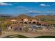 Beautiful community pool area surrounded by desert landscape and mountains in the background under a blue sky at 1915 N Bernard Cir, Mesa, AZ 85207