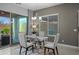 Elegant dining area with a glass table, chandelier, and access to the patio, perfect for entertaining at 1915 N Bernard Cir, Mesa, AZ 85207