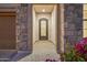 Elegant entryway with a decorative wrought-iron door, stone accents, and a welcoming pathway at 1915 N Bernard Cir, Mesa, AZ 85207