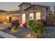 Beautiful home exterior features lush landscaping, warm lighting, and a cozy ambiance at twilight at 1915 N Bernard Cir, Mesa, AZ 85207