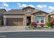 Charming single-story home featuring a manicured front yard and brick-paved driveway leading to a two-car garage at 1915 N Bernard Cir, Mesa, AZ 85207