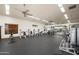 Bright, spacious gym with modern equipment, rubber flooring, ceiling fans, and inspirational wall decor at 1915 N Bernard Cir, Mesa, AZ 85207