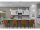 Stylish kitchen with a large central island, pendant lighting, stainless steel appliances, and modern cabinetry at 1915 N Bernard Cir, Mesa, AZ 85207
