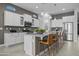 Bright kitchen featuring a spacious island with seating, stainless steel appliances, and white cabinetry at 1915 N Bernard Cir, Mesa, AZ 85207