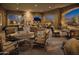 Elegant outdoor seating area with comfortable chairs, a fireplace, and scenic night views at 1915 N Bernard Cir, Mesa, AZ 85207