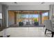 View from inside to outdoor patio featuring a cozy seating area, a fireplace, and well manicured lawn at 1915 N Bernard Cir, Mesa, AZ 85207
