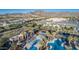 Overhead shot of the pool, with plenty of seating, lush landscaping, and mountain backdrop at 20546 W Summit Pl, Buckeye, AZ 85396