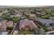 The aerial view captures a neatly kept backyard with sport court, landscaped yard, and tile roofing at 20546 W Summit Pl, Buckeye, AZ 85396