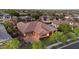 Expansive aerial view showcases a neighborhood home with a tile roof, lush landscaping, and paved driveway at 20546 W Summit Pl, Buckeye, AZ 85396