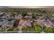 An aerial view displays community living featuring a solar-paneled home, mature trees, and well-kept streets at 20546 W Summit Pl, Buckeye, AZ 85396