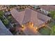 Aerial view of the expansive home featuring a tile roof, multiple garages, and a neatly paved driveway at 20546 W Summit Pl, Buckeye, AZ 85396