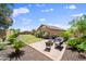 Beautiful backyard featuring a patio, lush greenery, and a well-maintained lawn at 20546 W Summit Pl, Buckeye, AZ 85396
