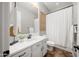 Bright bathroom with white vanity and decorative mirror above the toilet at 20546 W Summit Pl, Buckeye, AZ 85396