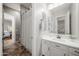 Bathroom with a shower featuring a white vanity and ample lighting at 20546 W Summit Pl, Buckeye, AZ 85396