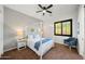 This bedroom offers a four poster bed, ceiling fan, and window with natural light at 20546 W Summit Pl, Buckeye, AZ 85396