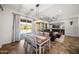 Open-concept dining area with a stylish table, seating, and sliding glass doors to the outdoor area at 20546 W Summit Pl, Buckeye, AZ 85396
