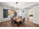 Elegant dining room featuring a wooden table, stylish lighting, and a modern barn door at 20546 W Summit Pl, Buckeye, AZ 85396