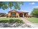 Charming single-story home with lush landscaping and a welcoming covered porch at 20546 W Summit Pl, Buckeye, AZ 85396