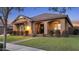 Charming home featuring a tile roof, covered porch, manicured lawn, and lovely shrubbery at 20546 W Summit Pl, Buckeye, AZ 85396