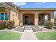 Covered front porch with arched entry and beautiful landscaping at 20546 W Summit Pl, Buckeye, AZ 85396