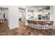 Stylish kitchen island with granite countertops, bar seating, and open access to the living area at 20546 W Summit Pl, Buckeye, AZ 85396
