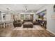 Spacious living room with large sectional sofa, TV, and plenty of natural light at 20546 W Summit Pl, Buckeye, AZ 85396
