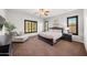 Comfortable main bedroom with a ceiling fan, chaise lounge, and plantation shutters at 20546 W Summit Pl, Buckeye, AZ 85396