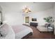 Bright main bedroom with a ceiling fan, chaise lounge, and dark wood dresser at 20546 W Summit Pl, Buckeye, AZ 85396