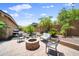 Inviting outdoor patio area with brick flooring, fire pit, and seating for entertaining at 20546 W Summit Pl, Buckeye, AZ 85396