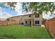 Expansive backyard featuring a lush green lawn, brick fence, and ample space for outdoor activities and entertainment at 20734 N 38Th St, Phoenix, AZ 85050
