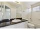 Bathroom with granite countertop vanity and a tub-shower combination with tile surround at 20734 N 38Th St, Phoenix, AZ 85050