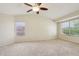 Spacious bedroom featuring neutral carpet, vaulted ceiling, and windows for ample natural light at 20734 N 38Th St, Phoenix, AZ 85050