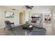 Spacious living room with a contemporary sofa, area rug, and an open layout flowing into the kitchen at 20734 N 38Th St, Phoenix, AZ 85050