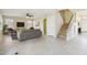 Inviting living room featuring neutral tones, tile flooring, and staircase access to the upper level at 20734 N 38Th St, Phoenix, AZ 85050