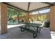 Shaded community picnic area with a metal table, benches, grill, and mature trees at 20734 N 38Th St, Phoenix, AZ 85050