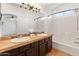 Bathroom featuring a double sink vanity, large mirror, and a shower-tub combo at 20809 N 1St Ave, Phoenix, AZ 85027