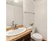 Cozy half bath featuring a granite vanity with a toilet and a decorative towel rack at 20809 N 1St Ave, Phoenix, AZ 85027