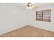 Empty bedroom featuring neutral carpet, a ceiling fan, and natural light at 20809 N 1St Ave, Phoenix, AZ 85027