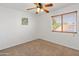 Neutral bedroom features a ceiling fan and a window with wood blinds providing natural light at 20809 N 1St Ave, Phoenix, AZ 85027