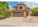 Two-story home featuring a two-car garage, desert landscaping, and a well-maintained front yard at 20809 N 1St Ave, Phoenix, AZ 85027