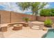 Backyard with pool features a custom fire pit and bench seating on a stone patio at 20809 N 1St Ave, Phoenix, AZ 85027