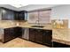 Well-appointed kitchen featuring granite countertops, stainless steel appliances, and dark cabinetry at 20809 N 1St Ave, Phoenix, AZ 85027