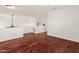 Spacious living room with dark wood flooring and neutral white walls at 20809 N 1St Ave, Phoenix, AZ 85027