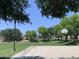 A community basketball court surrounded by green lawns and mature trees at 2150 S Lorena --, Mesa, AZ 85209