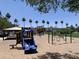 A community playground featuring swings and slides with shaded picnic tables at 2150 S Lorena --, Mesa, AZ 85209