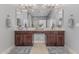 Bathroom featuring a double sink vanity with a large mirror and dark wood cabinets at 22166 N Lakeside Dr, Maricopa, AZ 85138